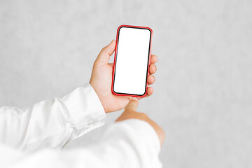 Mockup of a red smartphone in the hands of a man. On a light background.
