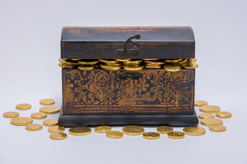 A small chest full of golden wrapped chocolate coins.