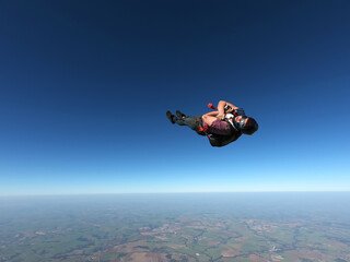 Parachutist performing a maneuver in a stretched body in free fall.