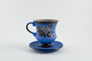 cup on saucers. vintage ceramic cup with ornaments.