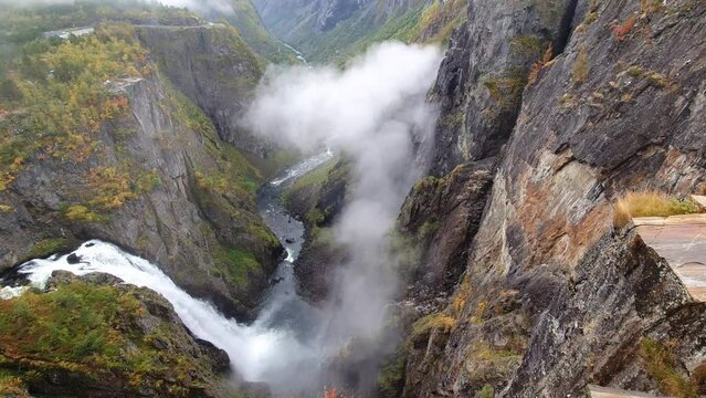 Galce into the depths of norway largest waterfall. along the impressive Valley of Voringfoss Waterfall in Noway. Steep depths