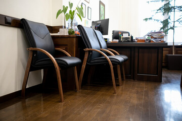 Director's office, desktop, documents, chairs for guests