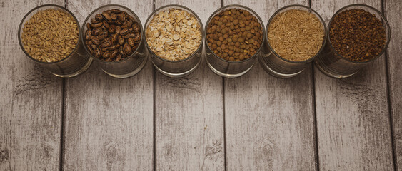 cereals in a glass standing on the table, buckwheat, rice, barley, beans, oatmeal, lentils