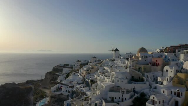Straight line drone shot of Oia in Santorini, Greece during sunset