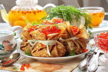 Pancake bags with minced meat and red caviar and sea buckthorn tea