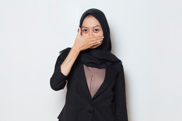 Asian business muslim woman holding her nose because of a bad smell
