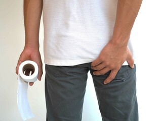 Man has diarrhea holding his bum on bathroom Background and hemorrhoid. closeup photo, blurred.