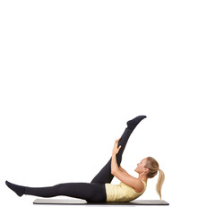 Warming up all her muscle groups. A fit young woman stretching out her legs on an exercise mat - isolated.
