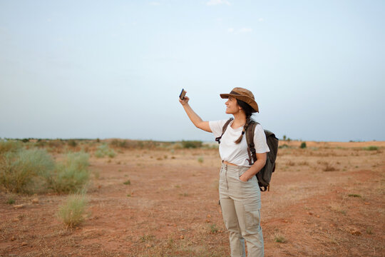 Woman taking selfie in desert