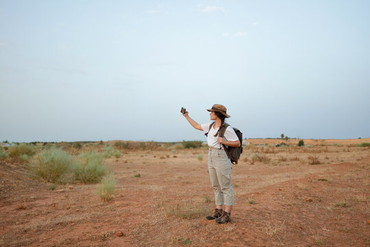 Woman taking selfie in desert