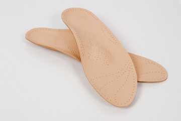Insoles isolated on a white background. Medical orthopedic insoles. Foot care. Insole cutaway layers. Treatment and prevention of flat feet and foot diseases. Inner soles of shoes.