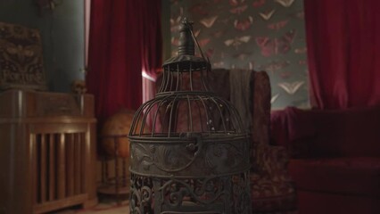 Bird cage detail in antique decorated study dim light burgundy drape - home decoration