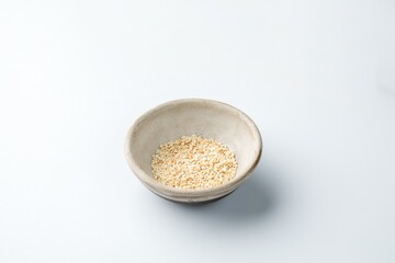 ceramic gravy boat with white sesame seeds