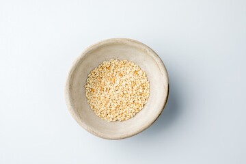ceramic gravy boat with white sesame seeds
