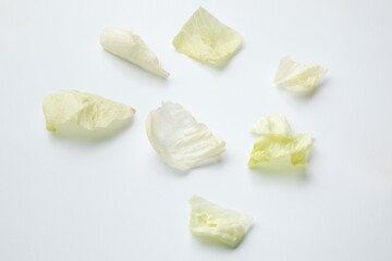 sliced Napa cabbage leaves lie on a white background
