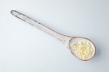 wooden spoon with grated pizza cheese