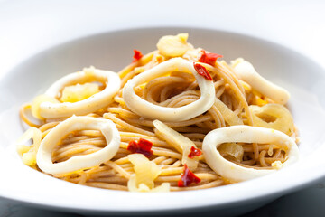 spaghetti with calamari, chilli pepper and onion