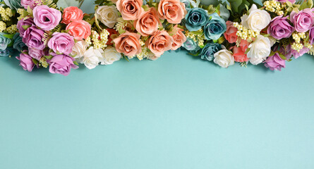 spring flowers different colors on a blue background, free space for text, elegant spring composition, flower frame