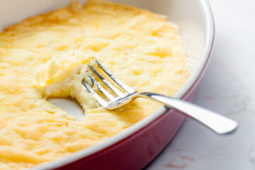 still life of cheese raclette in baking plate