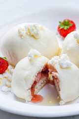 dumplings filled with strawberries served with cottage cheese
