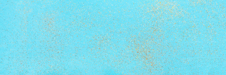 Small flying sparkles on blue holiday background. Festive abstract backdrop for banner.