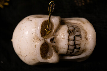 Close up of small skull and arrow