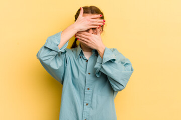 young pretty woman covering face with both hands saying no to the camera! refusing pictures or...