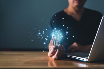 Young man holding glowing lightbulb with drawing brain and connection line, creative thinking ideas...