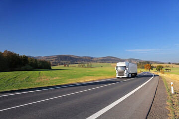 Landscape with a moving truck on the highway. 