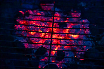 close up of  burning coals on grill