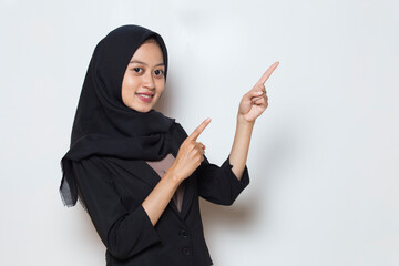 Young asian muslim business woman wearing hijab smiling confident pointing with fingers to different directions
