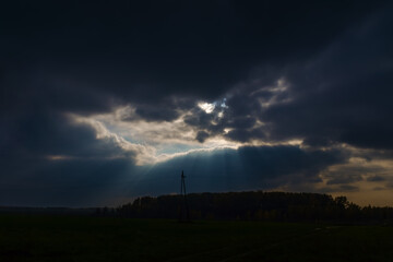 a ray of sun shine through the dark clouds on the field