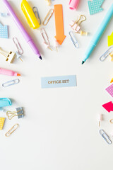Stationery, school supplies on a white table in bright pastel colors. Inscription.