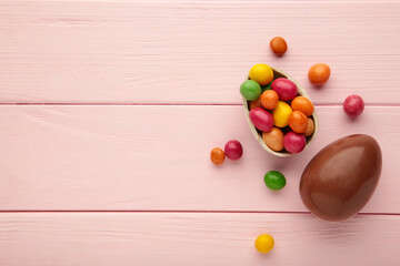 Chocolate easter eggs on wooden pink background.