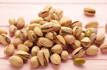 Pile of Pistachios on the pink background.
