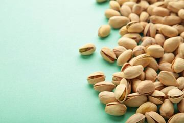 Pile of Pistachios on the green background.