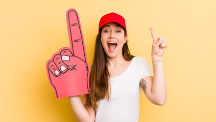 young pretty woman feeling like a happy and excited genius after realizing an idea. number one hand concept