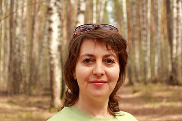 Portrait of a middle-aged woman for a walk in the woods.