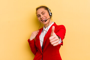 young pretty woman feeling proud,smiling positively with thumbs up. telemarketer concept
