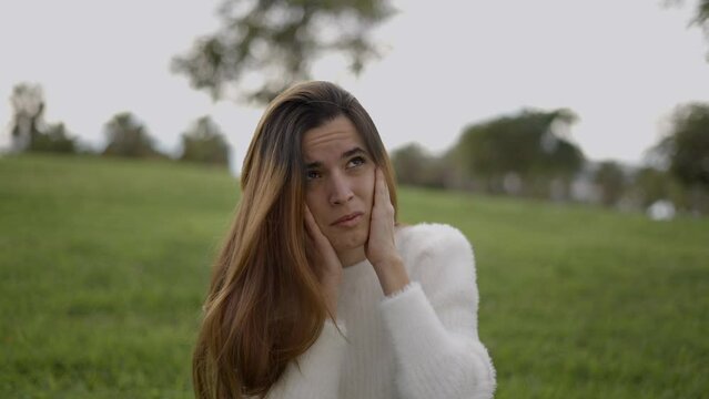 Young Woman With Hands Over Ears Panics In Reaction To Noise Outdoors