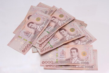 1000 baht Thai banknotes placed on a white background.