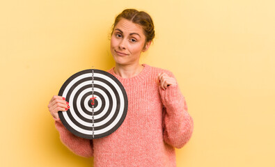 young pretty woman looking arrogant, successful, positive and proud. dart target concept