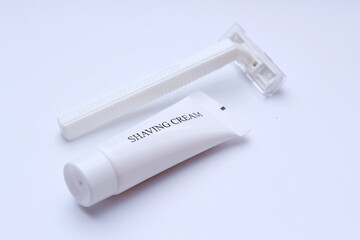 shaving cream and razor on white background.
