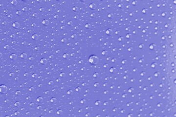 Very peri violet color water drops, abstract background or texture concept.