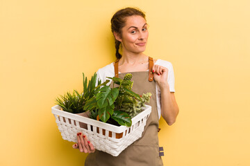 young pretty woman looking arrogant, successful, positive and proud. plants concept