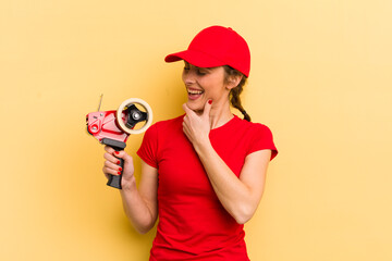 young pretty woman smiling with a happy, confident expression with hand on chin. packer concept
