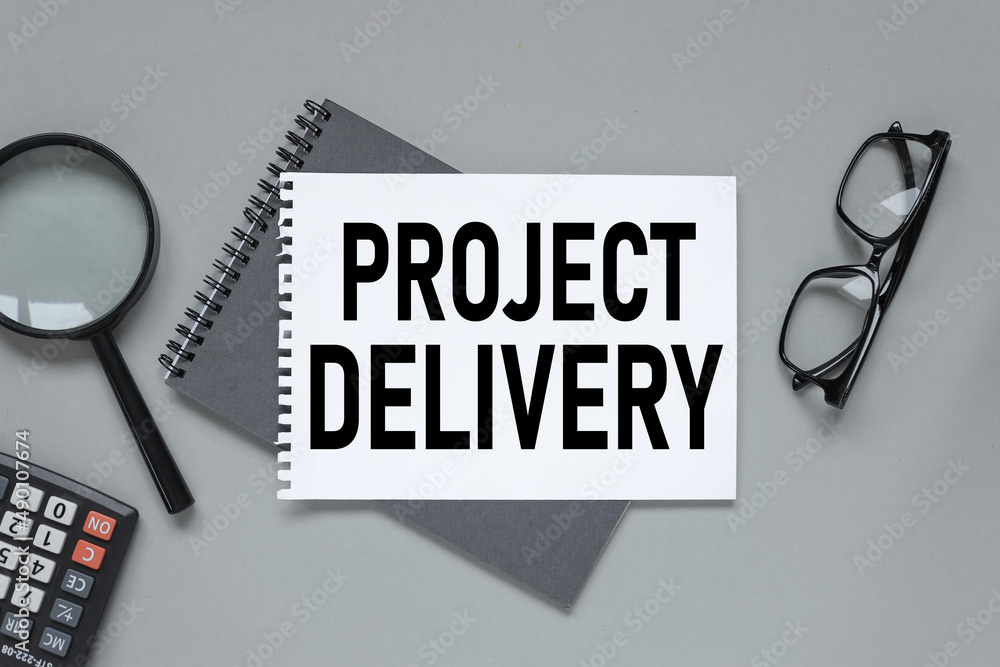 Poster gray background with stationery and notepad. text on white paper project delivery