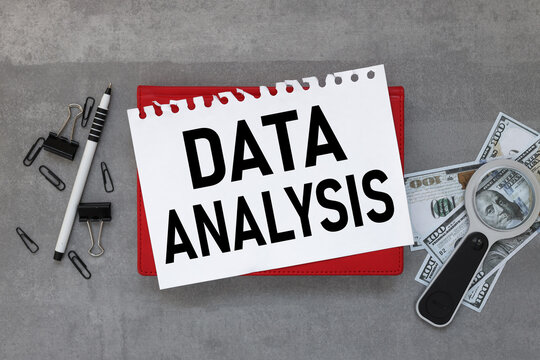 gray background with stationery and notepad. text on white paper. data analysis