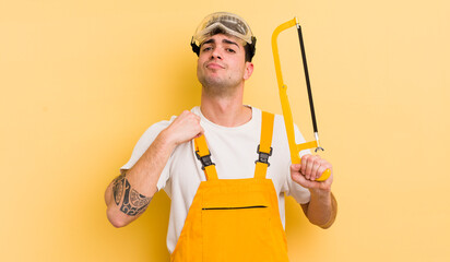 young handsome man looking arrogant, successful, positive and proud. handyman concept