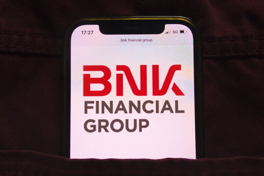 KONSKIE, POLAND - February 27, 2022: BNK Financial Group logo on mobile phone hidden in jeans pocket